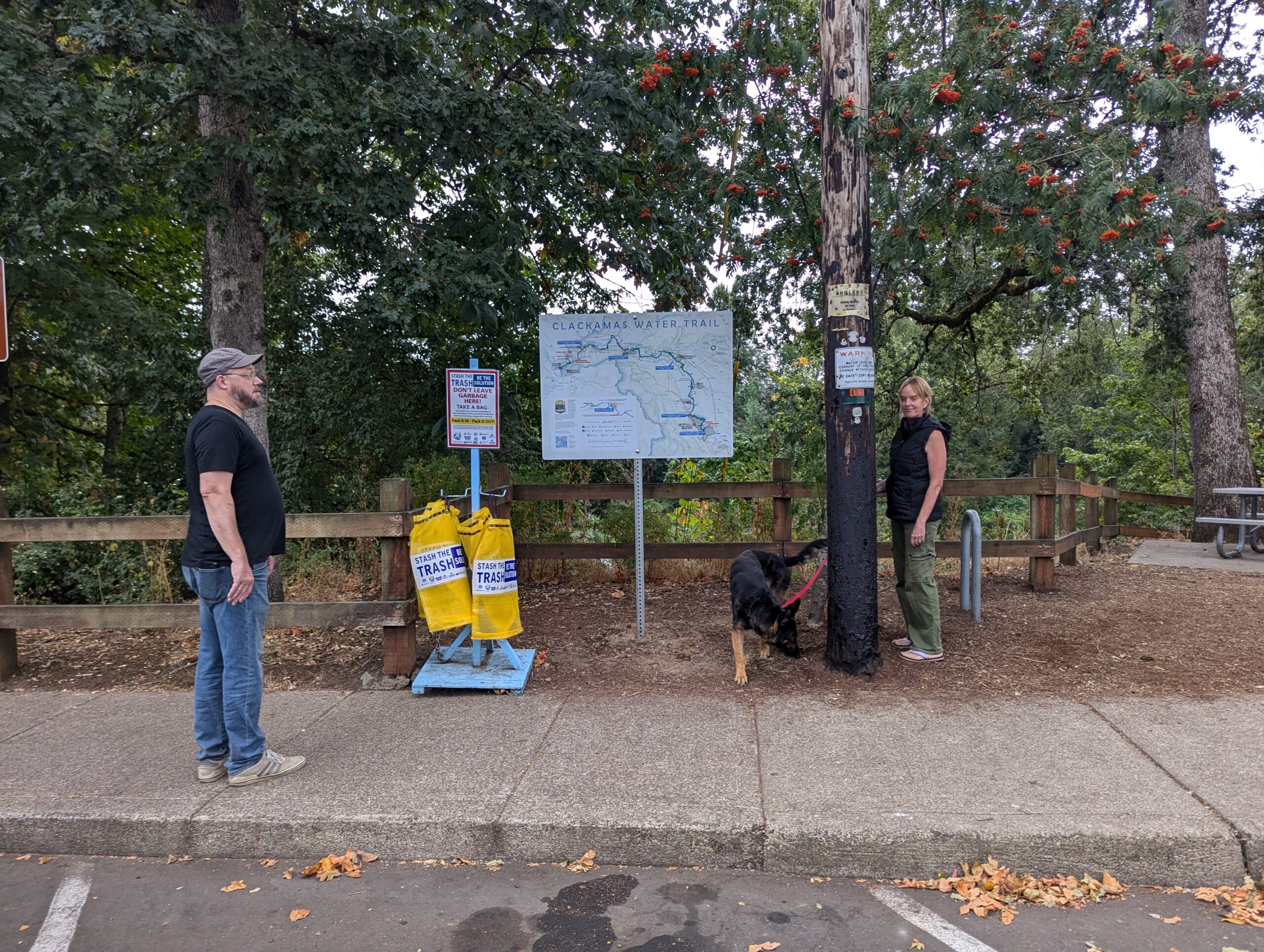 New CWT sign next to Stash the Trash Bag station, picnic area, bathrooms, and main path down to the river.